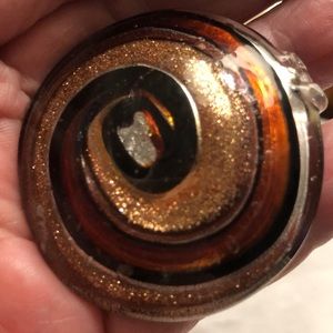 Glass Pendent. Swirls of multi colored glass of golds & brown.  2inch diameter